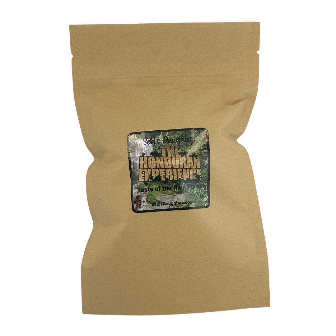 A kraft paper tea bag package with a label reading "Sebi's Daughters The Honduran Experience - Taste of the Rain Forest." The label features a lush green forest background with bold golden and white text. The product appears to be a natural tea blend.