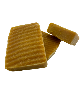 Three (3) Sebi’s Daughters Organic Turmeric Soap bar on a clear background, showcasing its natural golden color and smooth texture, made with shea butter, coconut oil, and organic turmeric for an alkaline lifestyle.